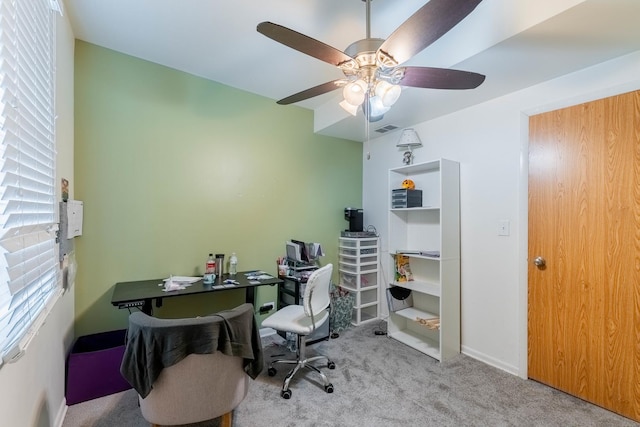 office with light carpet and ceiling fan