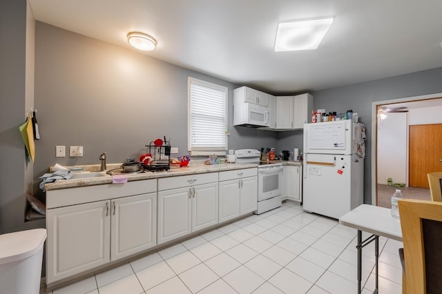 kitchen featuring white cabinetry, light tile patterned flooring, white appliances, and sink