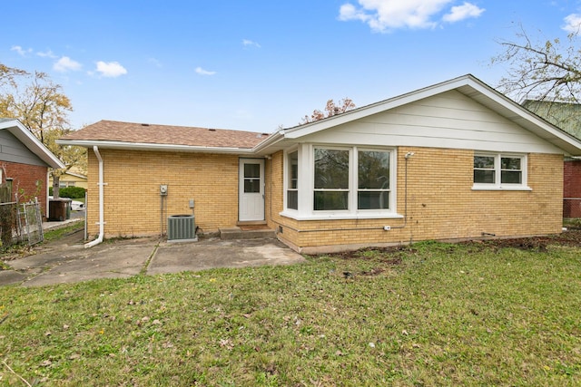 rear view of house featuring central AC, a yard, and a patio