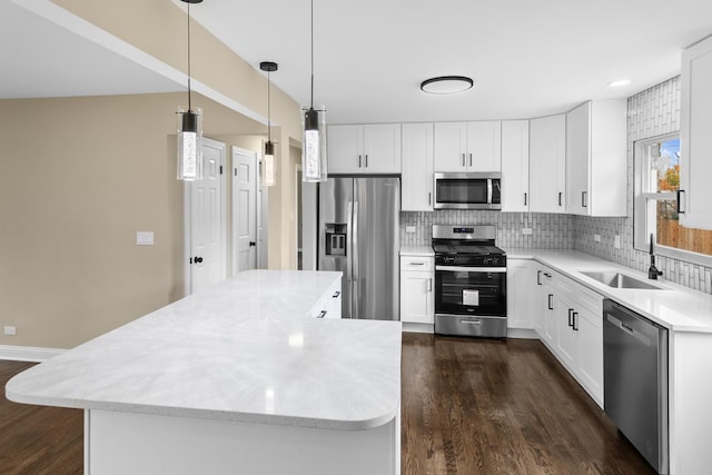 kitchen featuring pendant lighting, sink, white cabinets, and stainless steel appliances