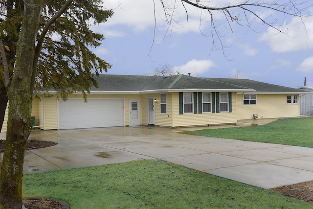 single story home featuring a garage and a front yard