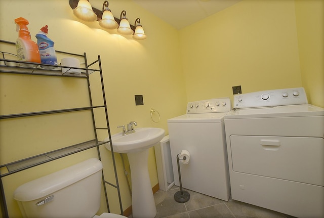 washroom featuring tile patterned floors, separate washer and dryer, and sink