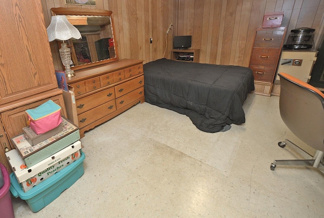 bedroom featuring wood walls