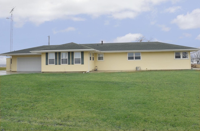 view of front of house with a front yard and a garage