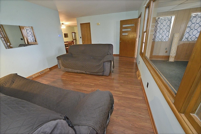 living room with hardwood / wood-style flooring and ceiling fan