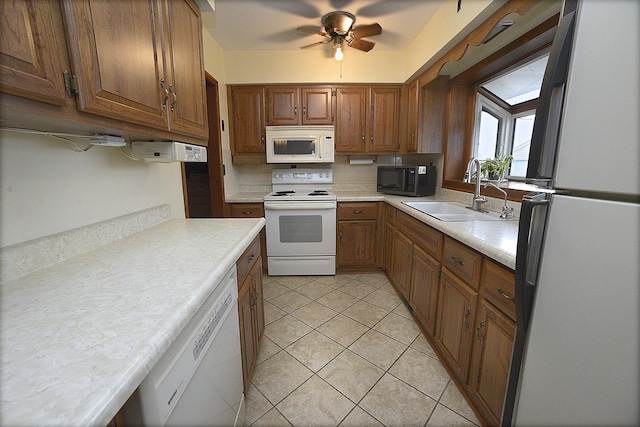 kitchen featuring ceiling fan, white appliances, sink, and light tile patterned floors