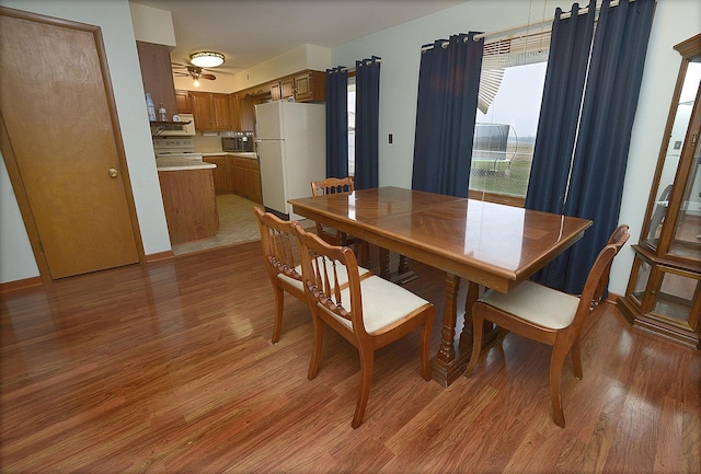 dining space with hardwood / wood-style flooring