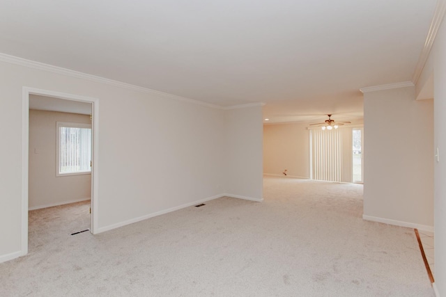 carpeted empty room featuring ceiling fan and crown molding