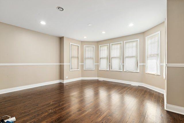 spare room with dark wood-type flooring