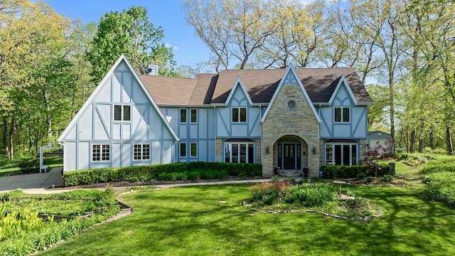2239 Pine Bluff Dr, Dixon, IL 61021 - english style home with stucco siding, stone siding, a front lawn, a chimney, and roof with shingles