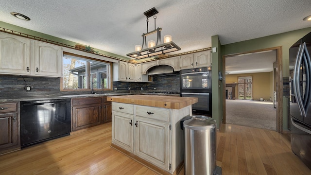 2239 Pine Bluff Dr, Dixon, IL 61021 - kitchen with black appliances, wood counters, plenty of natural light, light wood-type flooring, and a textured ceiling