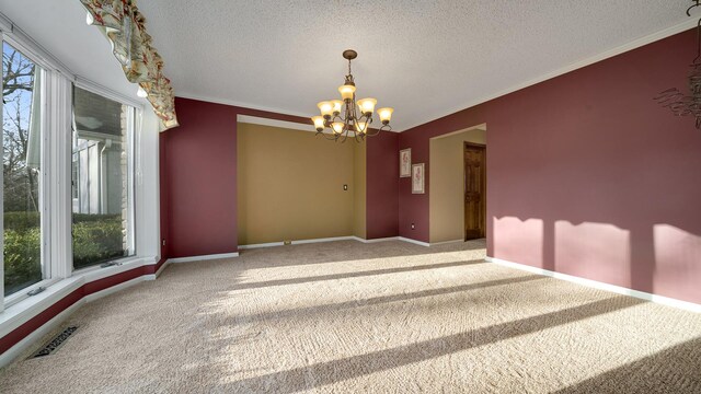 2239 Pine Bluff Dr, Dixon, IL 61021 - spare room with carpet, a chandelier, a textured ceiling, crown molding, and baseboards