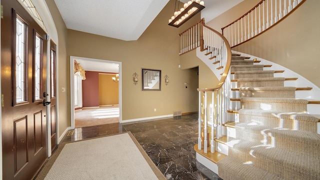 2239 Pine Bluff Dr, Dixon, IL 61021 - entrance foyer with a chandelier, baseboards, stairway, and dark marble finish floors