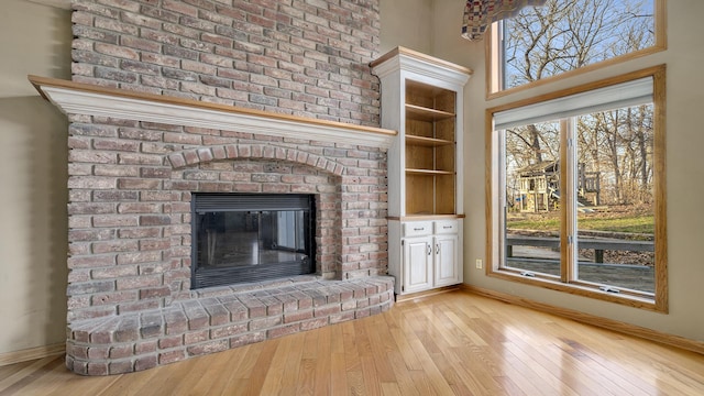 2239 Pine Bluff Dr, Dixon, IL 61021 - unfurnished living room with light wood-style flooring, a fireplace, and baseboards