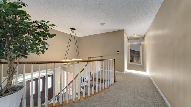 2239 Pine Bluff Dr, Dixon, IL 61021 - hallway featuring baseboards, carpet floors, a textured ceiling, and an upstairs landing