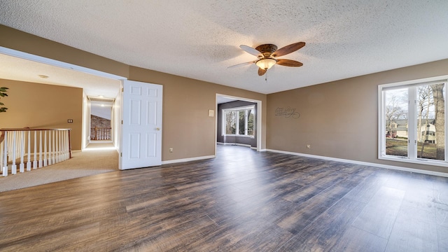 2239 Pine Bluff Dr, Dixon, IL 61021 - unfurnished room with a textured ceiling, healthy amount of natural light, a ceiling fan, and dark wood-style flooring