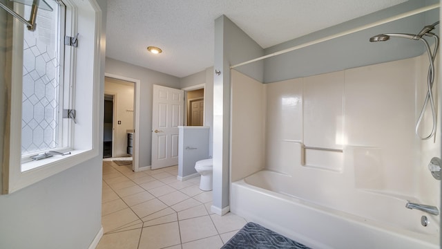 2239 Pine Bluff Dr, Dixon, IL 61021 - bathroom featuring baseboards, tile patterned floors, toilet, washtub / shower combination, and a textured ceiling