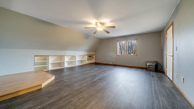 2239 Pine Bluff Dr, Dixon, IL 61021 - additional living space featuring a ceiling fan, built in shelves, dark wood-type flooring, lofted ceiling, and a wood stove