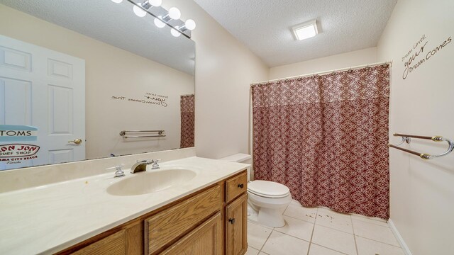 2239 Pine Bluff Dr, Dixon, IL 61021 - bathroom with toilet, tile patterned flooring, vanity, and a textured ceiling