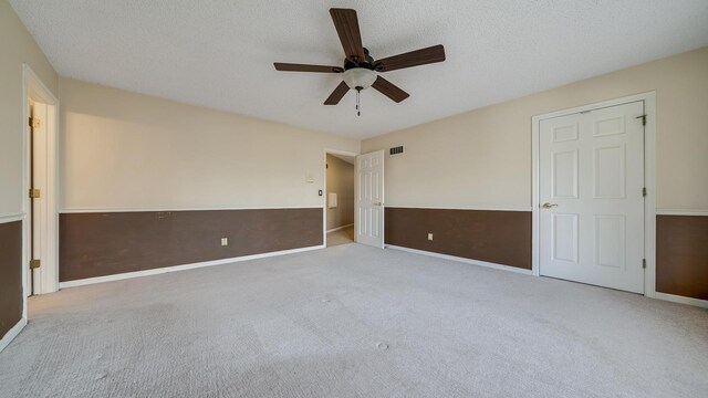 2239 Pine Bluff Dr, Dixon, IL 61021 - unfurnished bedroom featuring carpet floors, baseboards, a textured ceiling, and a ceiling fan