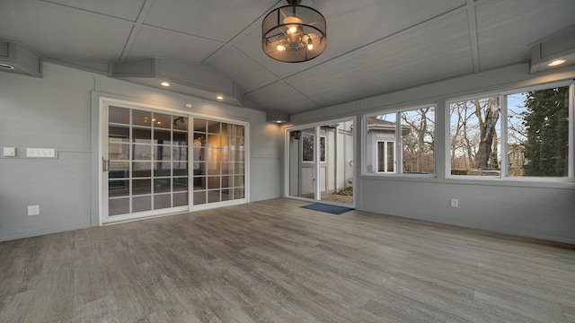 unfurnished sunroom featuring vaulted ceiling