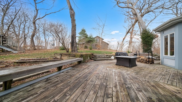 wooden terrace featuring a fire pit