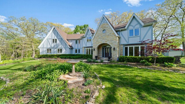 2239 Pine Bluff Dr, Dixon, IL 61021 - tudor-style house with stone siding, stucco siding, and a front yard