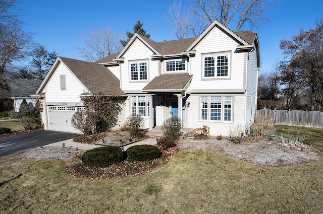 view of front property featuring a front lawn and a garage