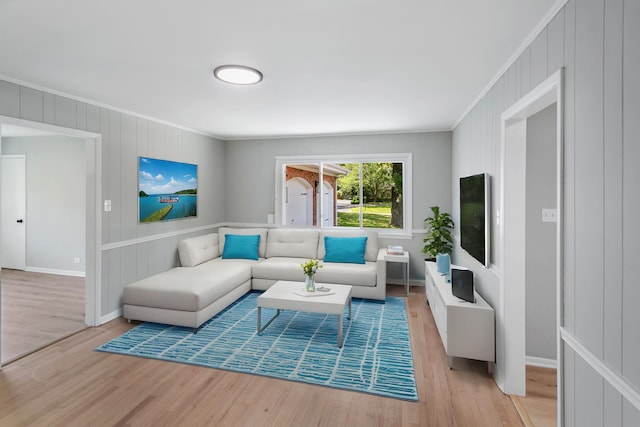 living room with light hardwood / wood-style flooring and ornamental molding