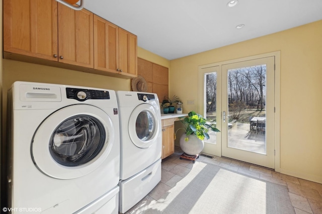 washroom featuring cabinets, separate washer and dryer, and french doors