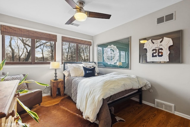 bedroom with ceiling fan and dark hardwood / wood-style floors