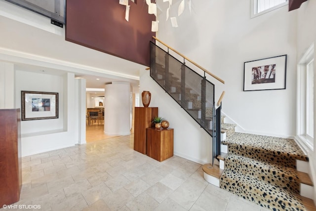 staircase featuring a high ceiling