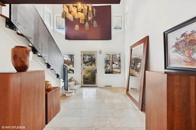 interior space with a notable chandelier and a towering ceiling