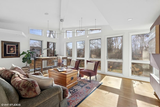 sunroom / solarium featuring a wealth of natural light and lofted ceiling