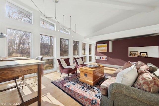 sunroom featuring lofted ceiling with beams