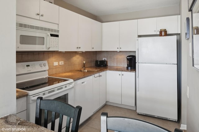 kitchen with white cabinetry, white appliances, and sink