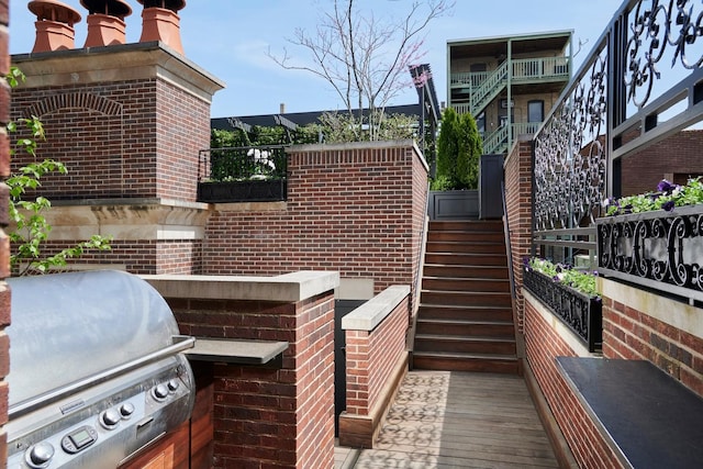 view of patio / terrace with stairway and a grill