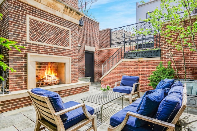 view of patio with an outdoor living space with a fireplace