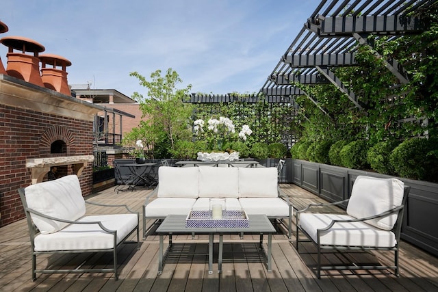 wooden terrace with an outdoor hangout area and a pergola