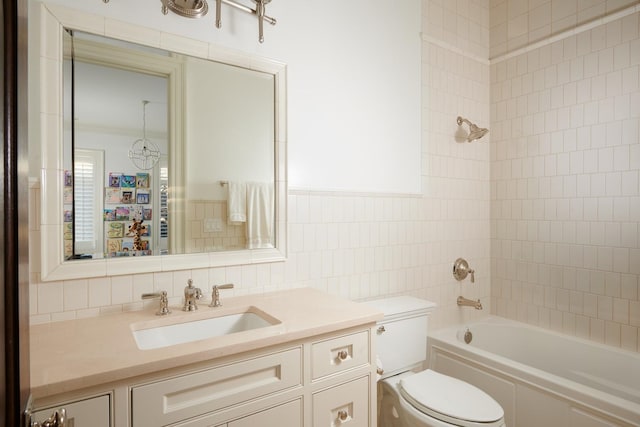 bathroom featuring bathing tub / shower combination, tile walls, toilet, and vanity