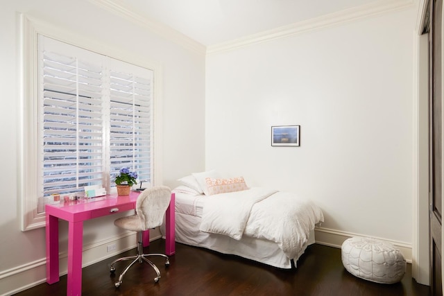bedroom featuring baseboards, ornamental molding, and wood finished floors