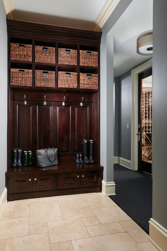 mudroom featuring baseboards and ornamental molding