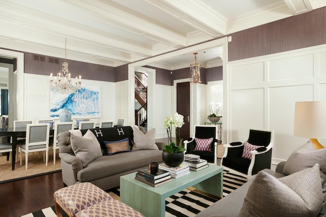living area with an inviting chandelier, dark wood-style flooring, a decorative wall, and visible vents