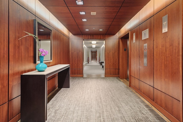 hallway featuring wood walls and wooden ceiling