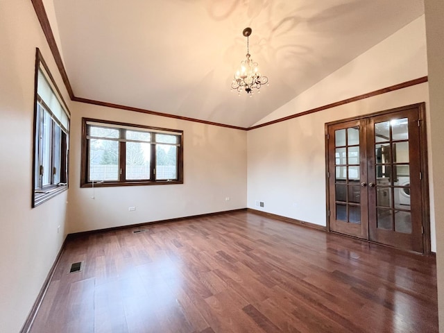 empty room featuring hardwood / wood-style flooring, french doors, lofted ceiling, and a notable chandelier