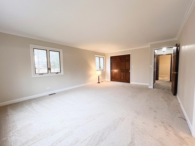 unfurnished bedroom with crown molding and light carpet