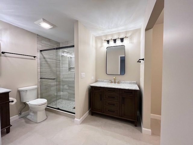 bathroom with vanity, toilet, and a shower with door