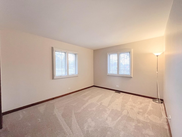 carpeted empty room with plenty of natural light