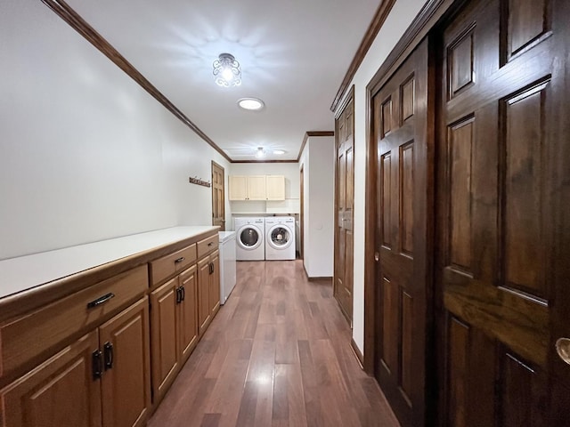 corridor featuring separate washer and dryer, dark hardwood / wood-style floors, and ornamental molding