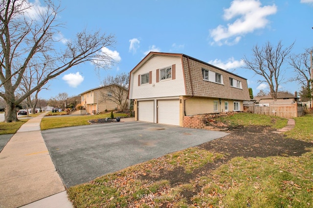 view of side of home with a lawn and a garage